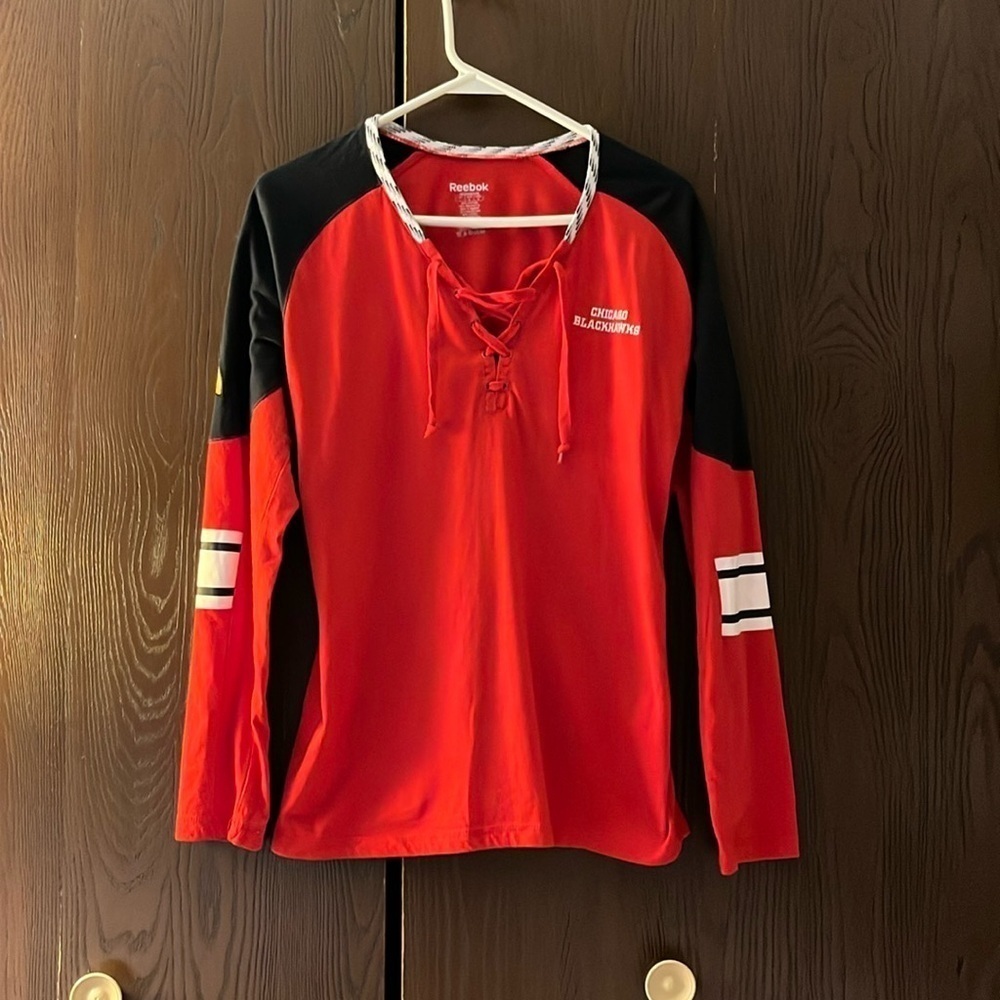 Reebok long sleeved red Chicago Blackhawks women’s shirt. Size L,